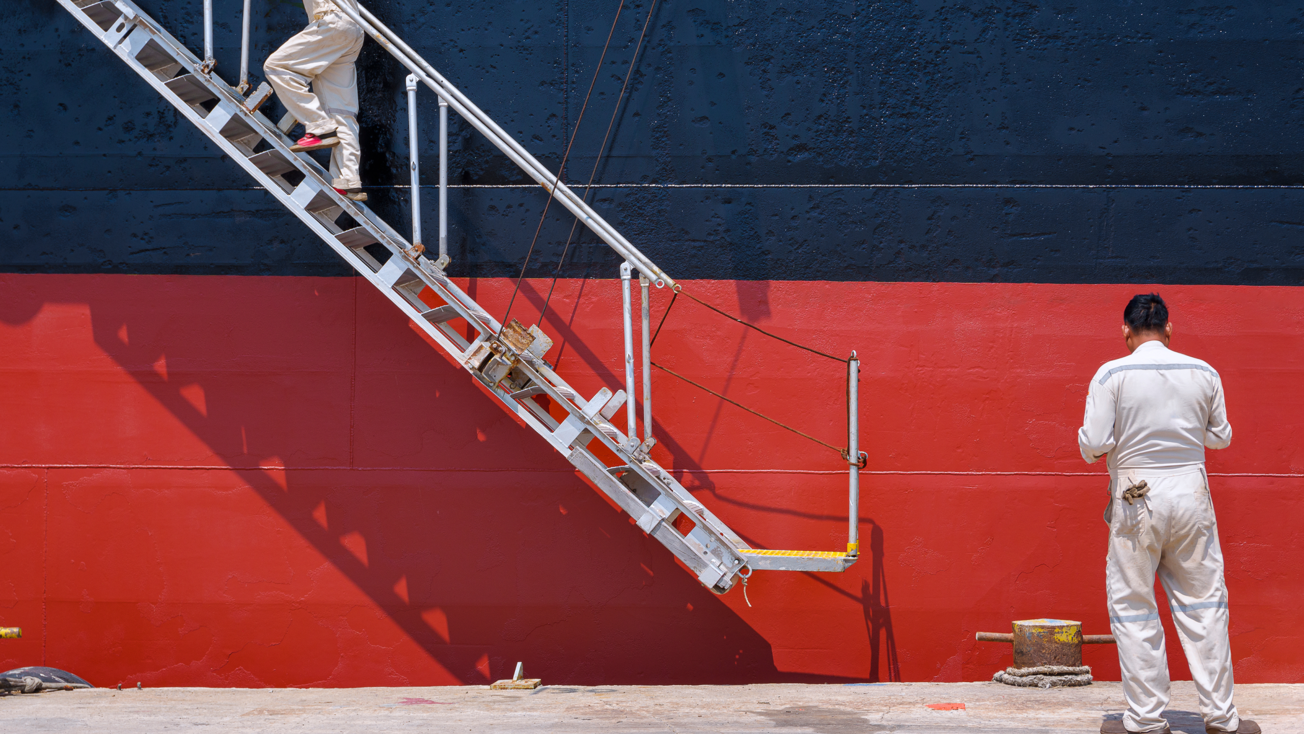 Crew member beside a vessel boarding ladder
